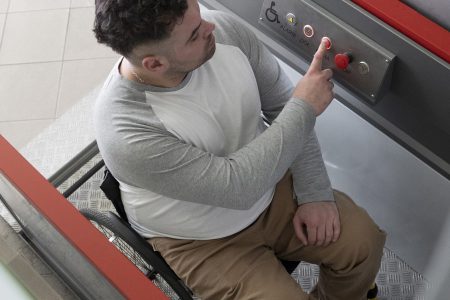 full-shot-man-wheelchair-using-elevator